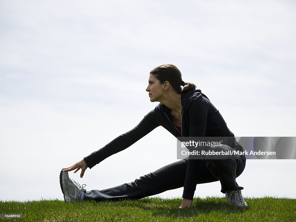 Profile of woman stretching outdoors