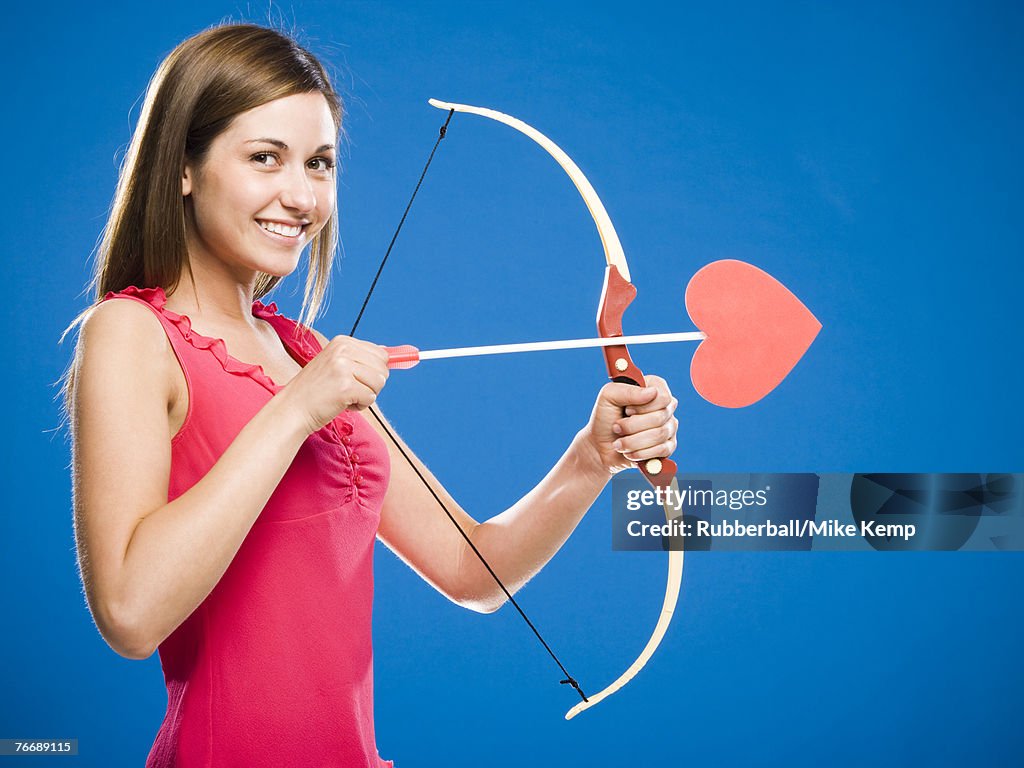 Woman with bow and arrow with heart