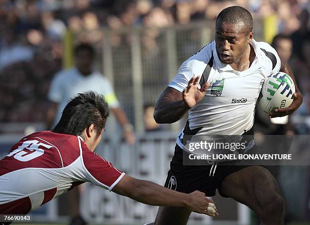Japan's fullback Go Aruga vies with Fiji's scrum-half and captain Mosese Rauluni during the rugby union World Cup group B match between Japan and...