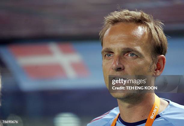 Denmark's coach Kenneth Heiner-Moller sings the national anthem ahead of their match against China in the Group D of their Women's World Cup 2007...