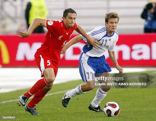 Poland's Dariusz Dudka and Finland's Joonas Kolkka vie for the ball during the Euro2008 Group A qualifying soccer match Finland vs. Poland at the...