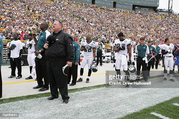 Coach Andy Reid of the Philadelphia Eagles observes the National Anthem during the game against the Green Bay Packers on September 9, 2007 at Lambeau...