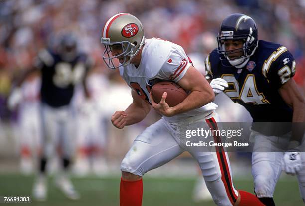 Wide receiver Ed McCaffrey of the San Francisco 49ers runs with the ball against the San Diego Chargers during a game at Jack Murphy Stadium on...