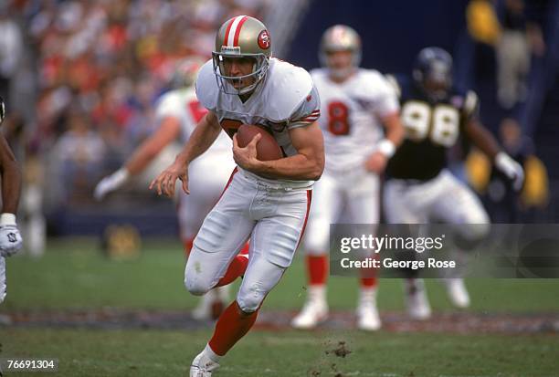 Wide receiver Ed McCaffrey of the San Francisco 49ers runs with the ball against the San Diego Chargers during a game at Jack Murphy Stadium on...