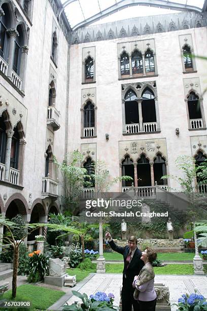Stan Kozak, Chief Horticulturist of the Gardner Museum, guides Mrs. Laura Bush though a tour of the interior courtyard garden, Tuesday, April 24...
