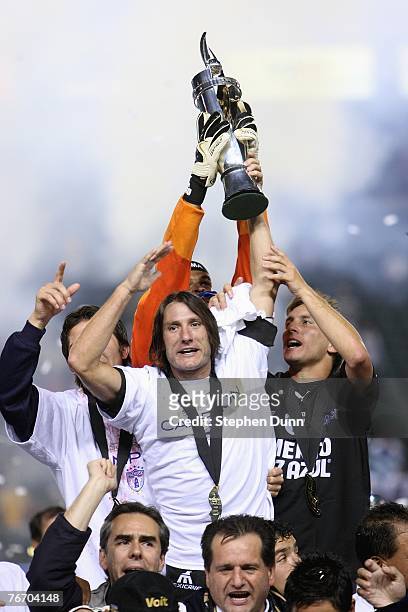 Captain Gabriel Caballero of Pachuca holds up the SuperLiga trophy overhead after they defeated the Los Angeles Galaxy 4-3 on penalty kicks after the...