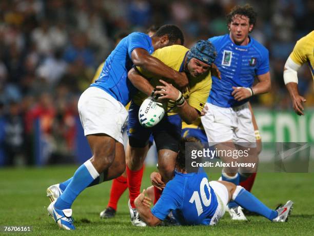 Alexandru Manta of Romania is tackled by Manoa Vosawai and Ramiro Pez of Italy during Match Twelve of the Rugby World Cup 2007 between Italy and...