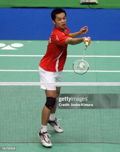 Taufik Hidayat of Indonesia returns a shot against Kay Bin Yeoh of