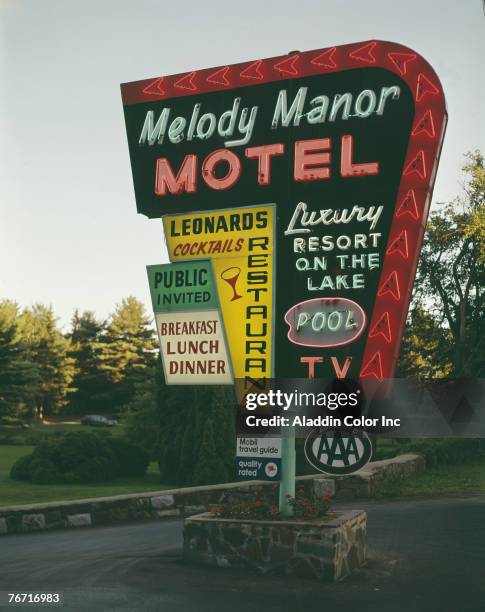 Close-up view of the illuminated neon signboard of the Melody Manor Motel, a 'Luxury Resort on the Lake,' Lake George, New York, 1960s.