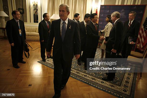 President George W. Bush turns on the charm as he welcomes his Chinese counterpart Hu Jintao at a meeting on the sidelines of the G8 Summit on July...