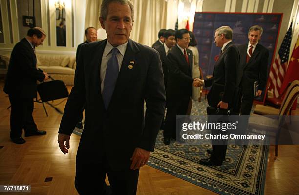 President George W. Bush turns on the charm as he welcomes his Chinese counterpart Hu Jintao at a meeting on the sidelines of the G8 Summit on July...