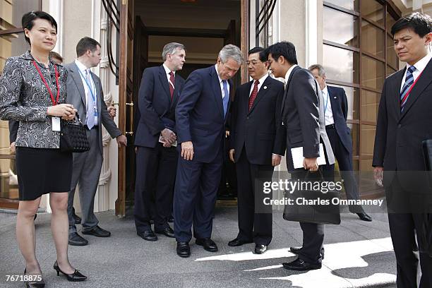 President George W. Bush turns on the charm as he welcomes his Chinese counterpart Hu Jintao at a meeting on the sidelines of the G8 Summit on July...