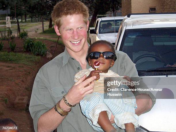 Undated Clarence House handout photo of Prince Harry with a child from one of the projects being helped by the Lesotho Fund. Prince Harry has thanked...