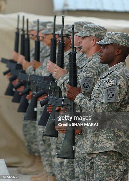 Soldiers attend a ceremony at Bagram air base, 50 kms north of Kabul, 11 September 2007 in remembrance of the victims of the 11 September 2001 terror...