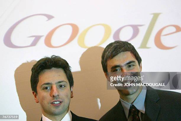 Picture taken 07 October 2004 shows Google founders Sergey Brin and Larry Page posing for photographers prior to presenting their new Google Print...