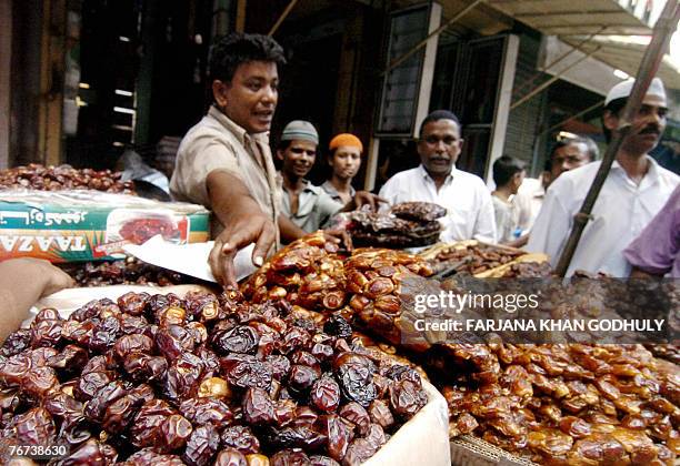 Bangladeshi vendor sells dates in the old part of Dhaka, 14 September 2007, during the first day of the holy month of Ramadan. Ramadan, the ninth and...