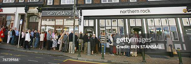 Customers queue to enter a Northern Rock branch in Bromley, in south-east London, 14 September 2007. The Bank of England has stepped in to provide...