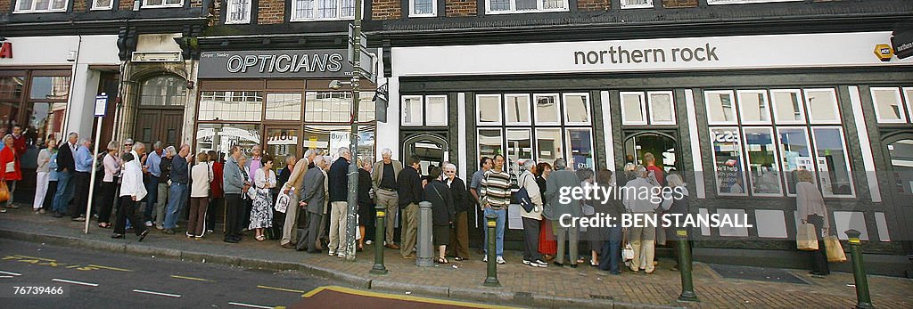 Customers queue to enter a Northern Rock