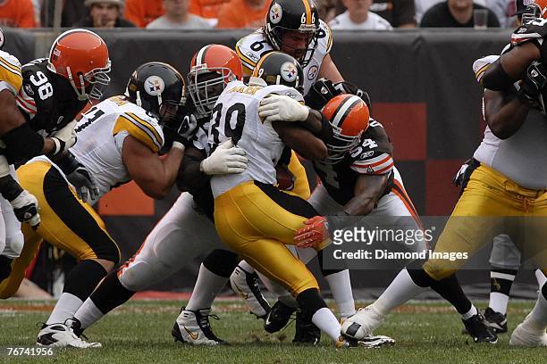 Defensive lineman Ted Washington of the Cleveland Browns tackles running back Willie Parker of the Pittsburgh Steelers as Andra Davis assists and...