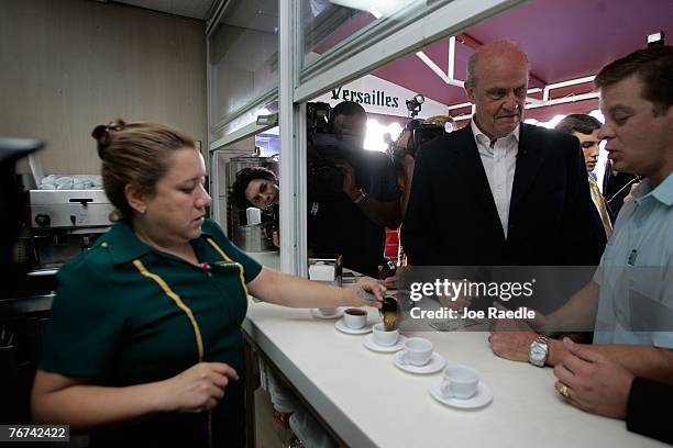 Actor and former U.S. Senator Fred Thompson and Rep. Carlos Lopez-Cantera wait as a waitress prepares a cup of Cuban coffee for them to drink during...