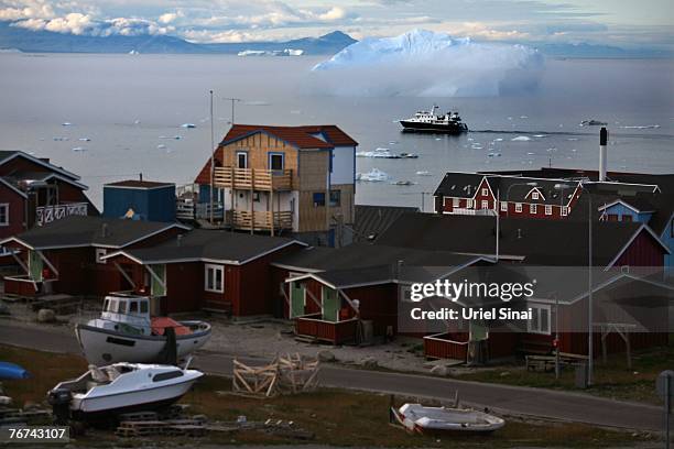 General view as a boat sails in the water August 25 in the town of Ilulissat Greenland. Even though the disappearing ice cap could lead to higher sea...