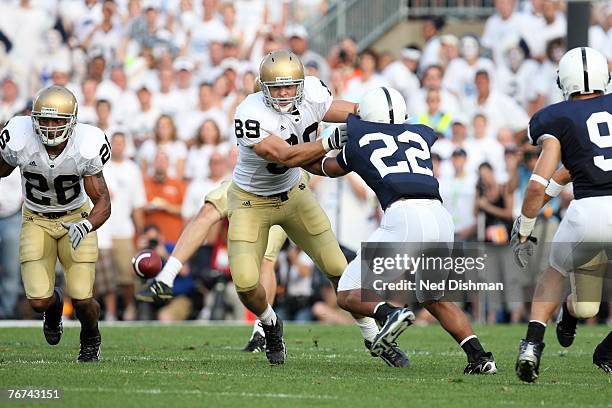 Tight end John Carlson of the University of Notre Dame Fighting Irish fights through blockers against Evan Royster of the Penn State Nittany Lions at...