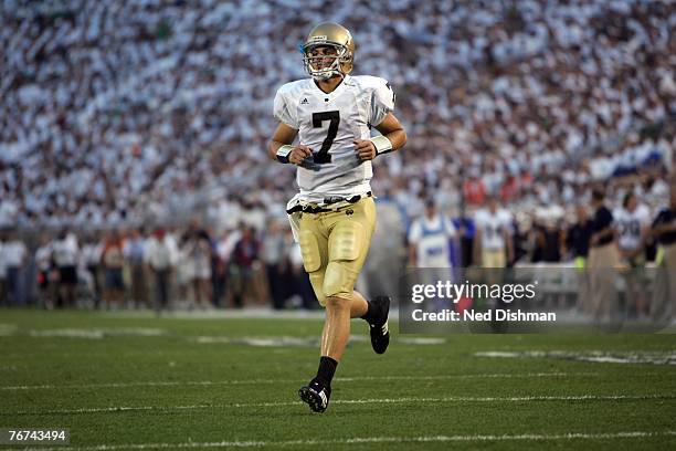 Quarterback Jimmy Clausen of the University of Notre Dame Fighting Irish runs onto the field against the Penn State Nittany Lions at Beaver Stadium...
