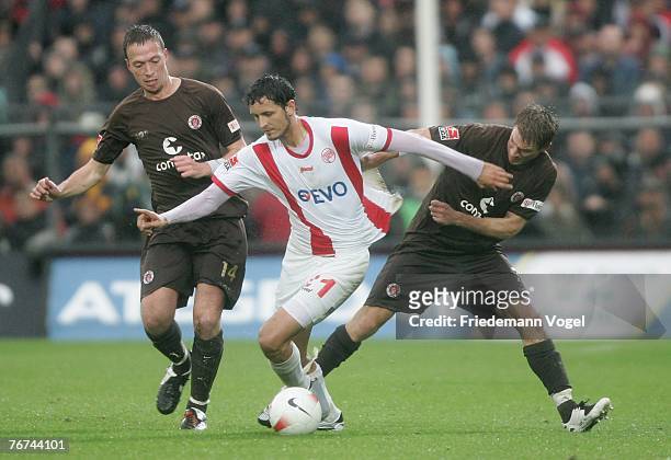 Marcel Eger and Marvin Braun of St.Pauli and Dino Toppmoeller of Offenbach fight for the ball during the Second Bundesliga match between FC St.Pauli...