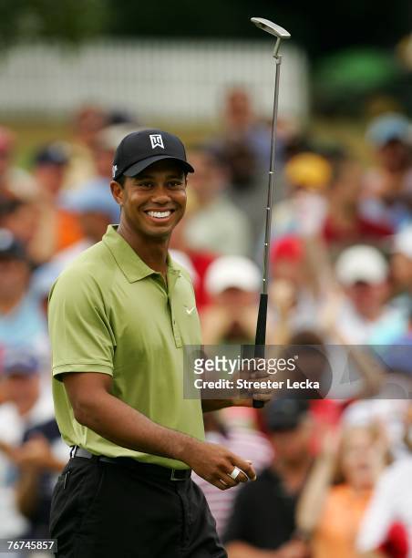 Tiger Woods reacts to making eagle at the 9th hole during the second round of the TOUR Championship, the final event of the new PGA TOUR Playoffs for...