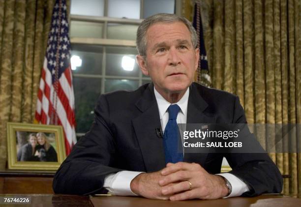 President George W. Bush sits at his desk in the Oval Office of the White House 13 September 2007 in Washington, DC after a prime-time speech...