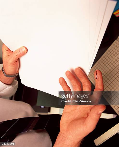 hand with paper cut - cut on finger stock pictures, royalty-free photos & images