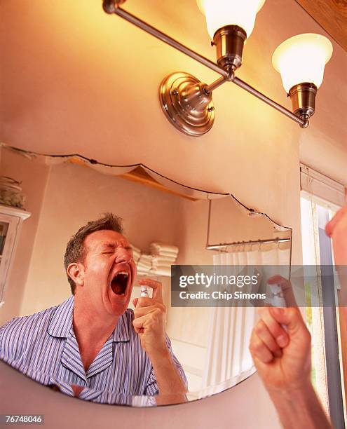 man with breath spray - bad breath stock pictures, royalty-free photos & images