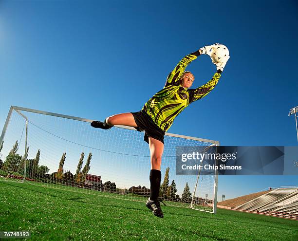 soccer goalie blocking ball - woman goalie stock pictures, royalty-free photos & images