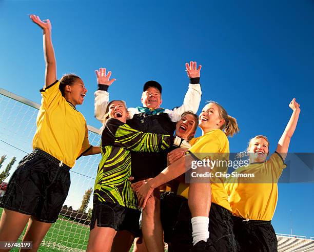 soccer team lifting coach - soccer team stock pictures, royalty-free photos & images