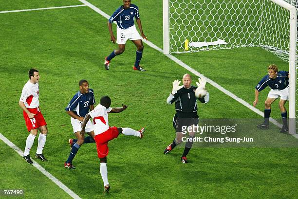 Emmanuel Olisadebe of Poland scores the first goal during the FIFA World Cup Finals 2002 Group D match between Poland and USA played at the Daejeon...