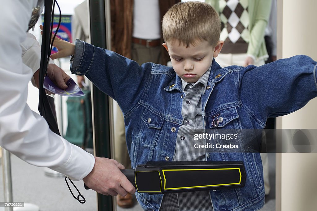 Boy at an airport security checkpoint