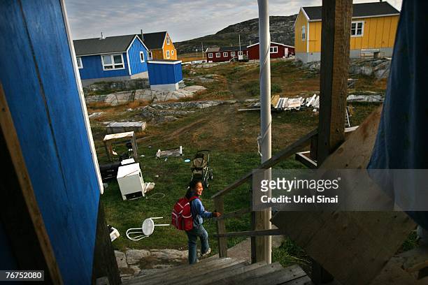 Eleven-year-old Inuit fisherman's daughter Caria Rosbach heads for school August 27, 2007 in her home village of Ilimanaq, Greenland. Her father,...