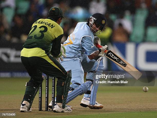 Robin Uthappa of India runs the ball to third man with Kamran Akmal of Pakistan looking on during the ICC Twenty20 Cricket World Championship match...