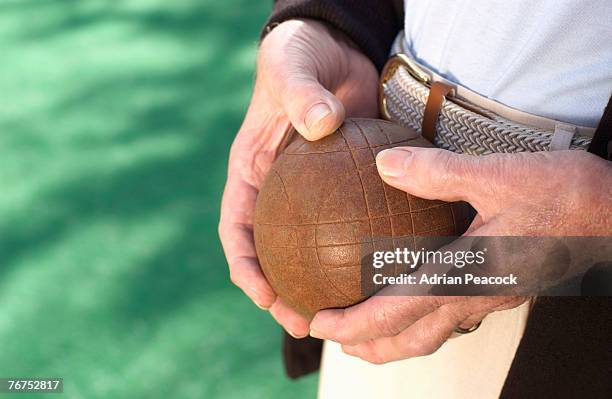 man holding a bocce ball - bocce stock pictures, royalty-free photos & images