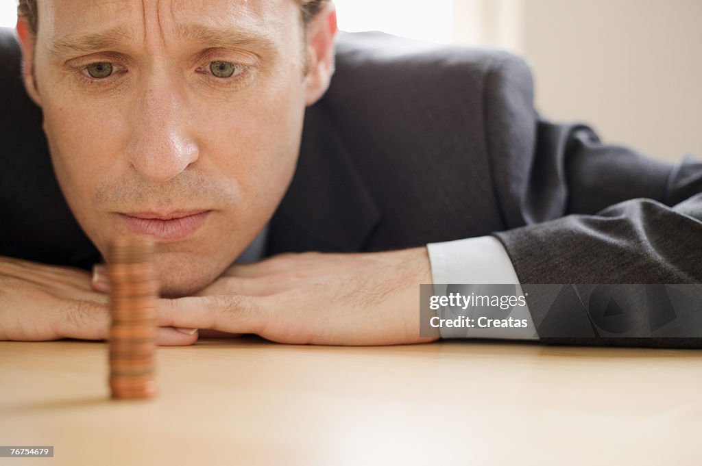 Man with stack of coins