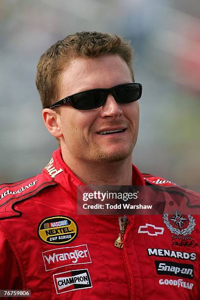 Dale Earnhardt Jr., driver of the Budweiser Chevrolet, stands on pit road during qualifying for the NASCAR Nextel Cup Series Sylvania 300 at New...