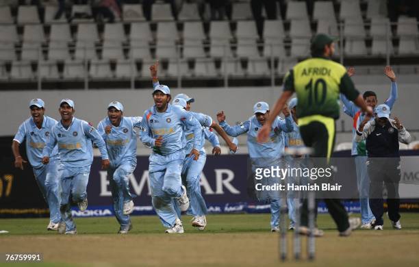 India celebrate as Shahid Afridi of Pakistan misses the stumps in a bowl off giving victory to India after the match was tied at the end of both...
