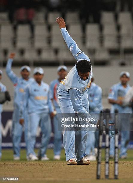 Robin Uthappa of India takes a bow after hitting the stumps in a bowl off eventually won by India after the match was tied at the end of both teams...