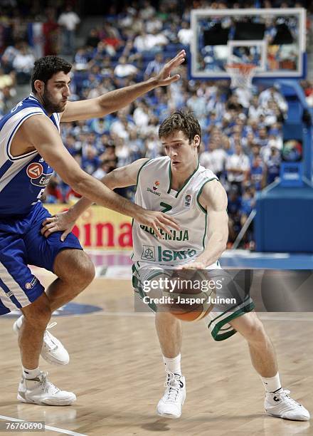 Goran Dragic of Slovenia drives around Ioannis Bourousis of Greece during the FIBA Eurobasket 2007 quarter final match between Slovenia and Greece at...