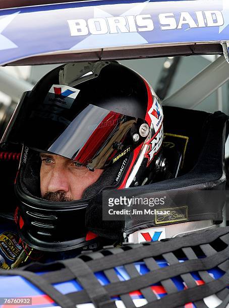 Boris Said, driver of the Valvoline Dodge, sits in his car during qualifying for the NASCAR Nextel Cup Series Sylvania 300 at New Hampshire...