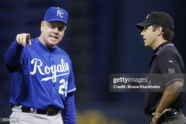 Buddy Bell, manager of the Kansas City Royals, discusses a call with umpire James Hoye of in a game against the Minnesota Twins at the Humphrey...