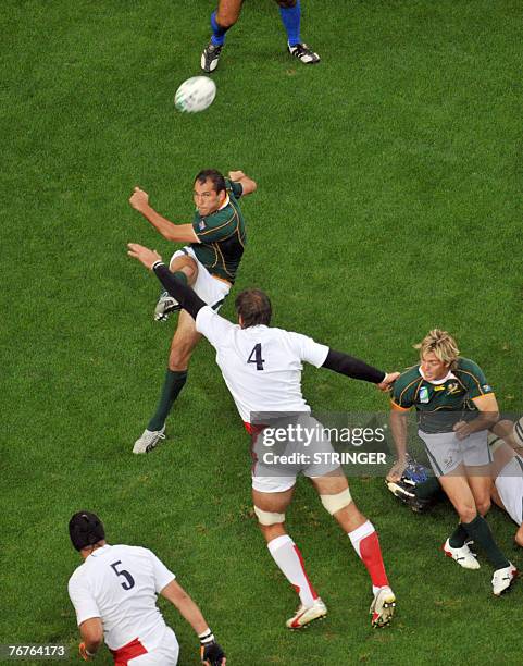 South Africa's scrum-half Fourie du Preez kicks over England's lock Simon Shaw during the rugby union World Cup group A match between South Africa...