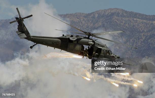 An HH-60G Pavehawk helicopter drops flares during a U.S. Air Force firepower demonstration at the Nevada Test and Training Range September 14, 2007...