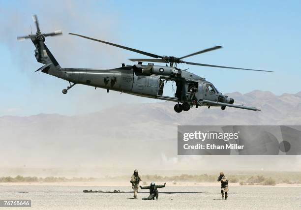 The crew of an HH-60G Pavehawk helicopter simulates a rescue of a downed pilot during a U.S. Air Force firepower demonstration at the Nevada Test and...