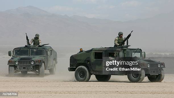 Airmen in Humvees participate in a U.S. Air Force firepower demonstration at the Nevada Test and Training Range September 14, 2007 near Indian...